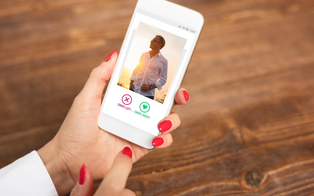 woman looks at online dating profile