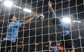 Uruguay's striker Luis Suarez (L) stops the ball with the hand leading to a red card and a penalty for Ghana during the extra-time of 2010 World Cup quarter-final match Uruguay vs Ghana on 2 July, 2010.