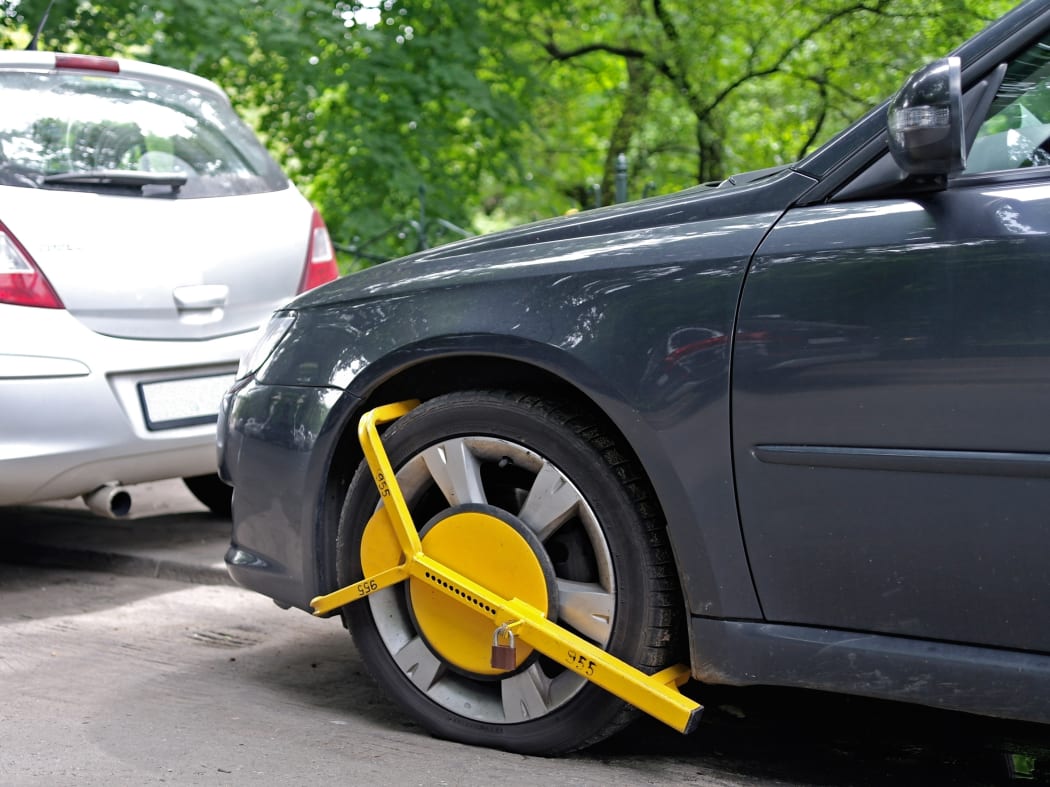 Wheel clamp mounted on parked car