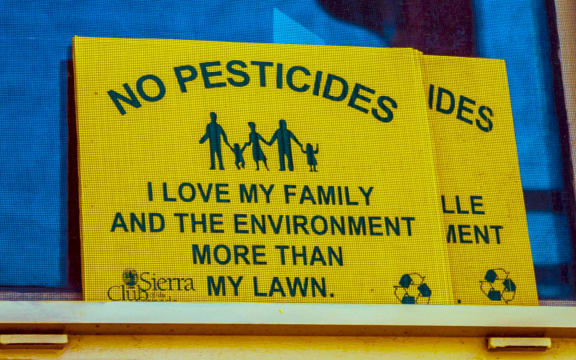 No Pesticides / I love my family and the environment more than my lawn. Sierra club window sign in Halifax, Nova Scotia, Canada.