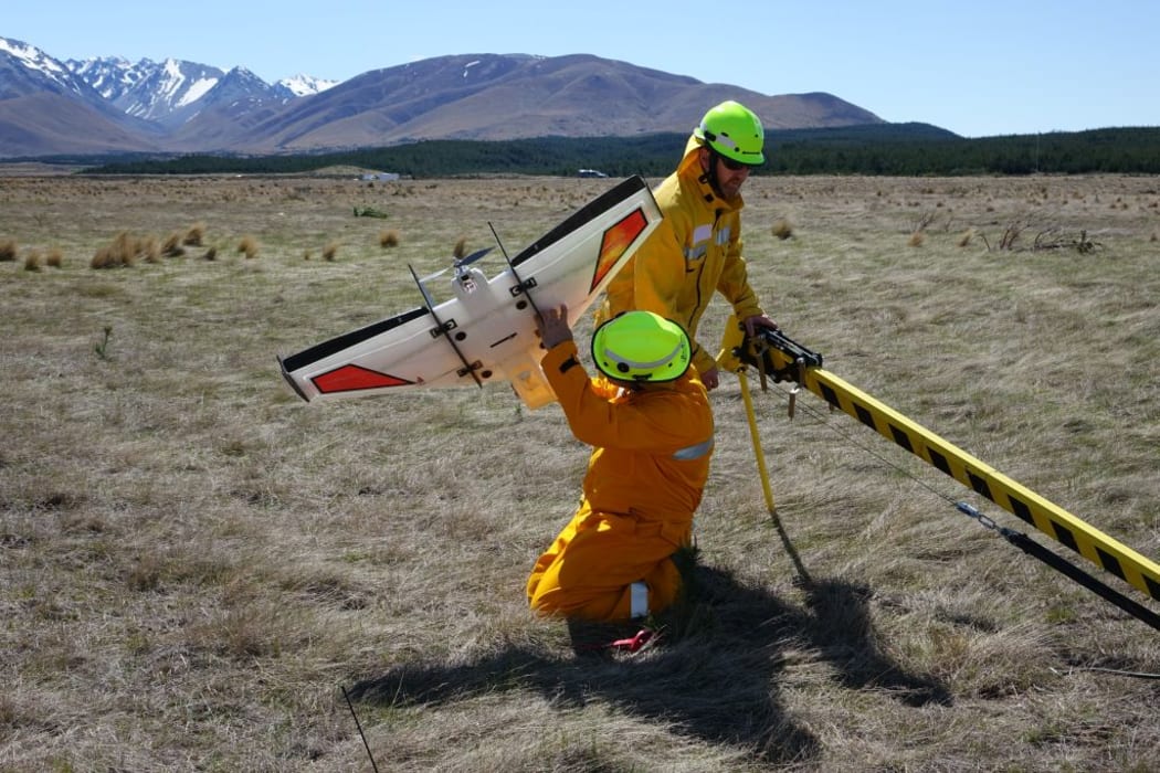 Marwan Katurji and Paul Bealing, from the University of Canterbury, are preparing an UAV to fly above the flames.