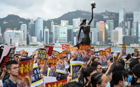 Protesters gather to take part in a march to the West Kowloon railway station, where high-speed trains depart for the Chinese mainland, during a demonstration against a proposed extradition bill in Hong Kong on July 7, 2019.