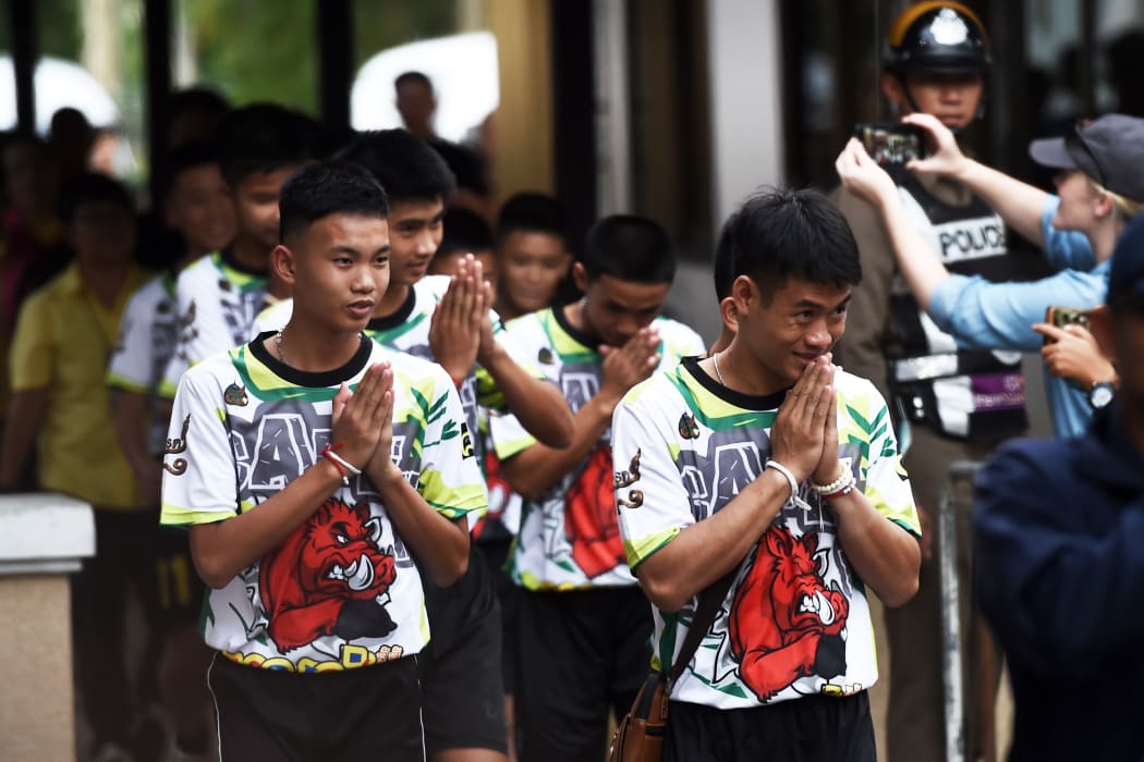 Some of the twelve Thai boys, rescued from a flooded cave after being trapped, arrive to attend a press conference in Chiang Rai on July 18, 2018, following their discharge from the hospital.