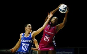Anna Harrison and Jhanielle Folwer-Reid contest for the ball in an ANZ Premiership netball match.