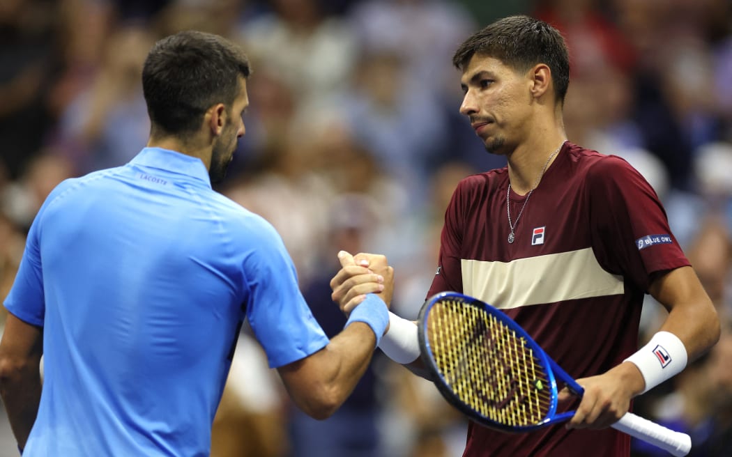 Alexei Popyrin of Australia shakes hands with Novak Djokovic of Serbia after winning their men's singles third round match on day five of the 2024 US Open at USTA Billie Jean King National Tennis Center on August 30, 2024 in the Flushing neighborhood of the Queens borough of New York City.   Sarah Stier/Getty Images/AFP (Photo by Sarah Stier / GETTY IMAGES NORTH AMERICA / Getty Images via AFP)