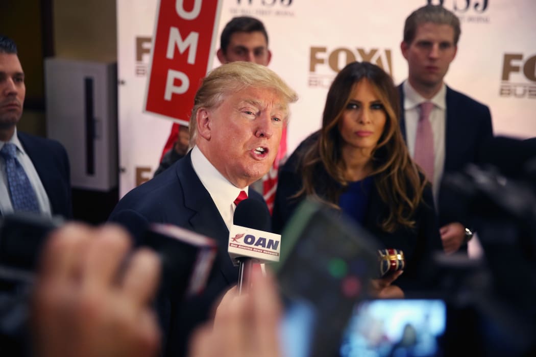 Donald Trump and his wife Melania speak to media after a Republican presidential debate.