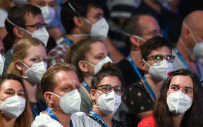 People wear face masks as German pop singer Tim Bendzko performs on stage at the Arena in  Leipzig, eastern Germany on August 22, 2020