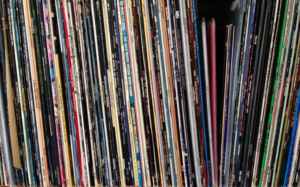 A close up of someone's record collection, sitting on a shelf