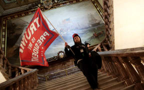 A protester holds a Trump flag inside the US Capitol Building near the Senate Chamber on January 06, 2021 in Washington, DC.