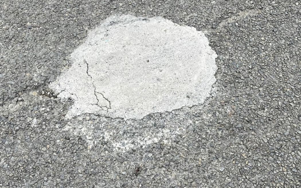 A DIY pothole cement fill on a road in Palmerston North.