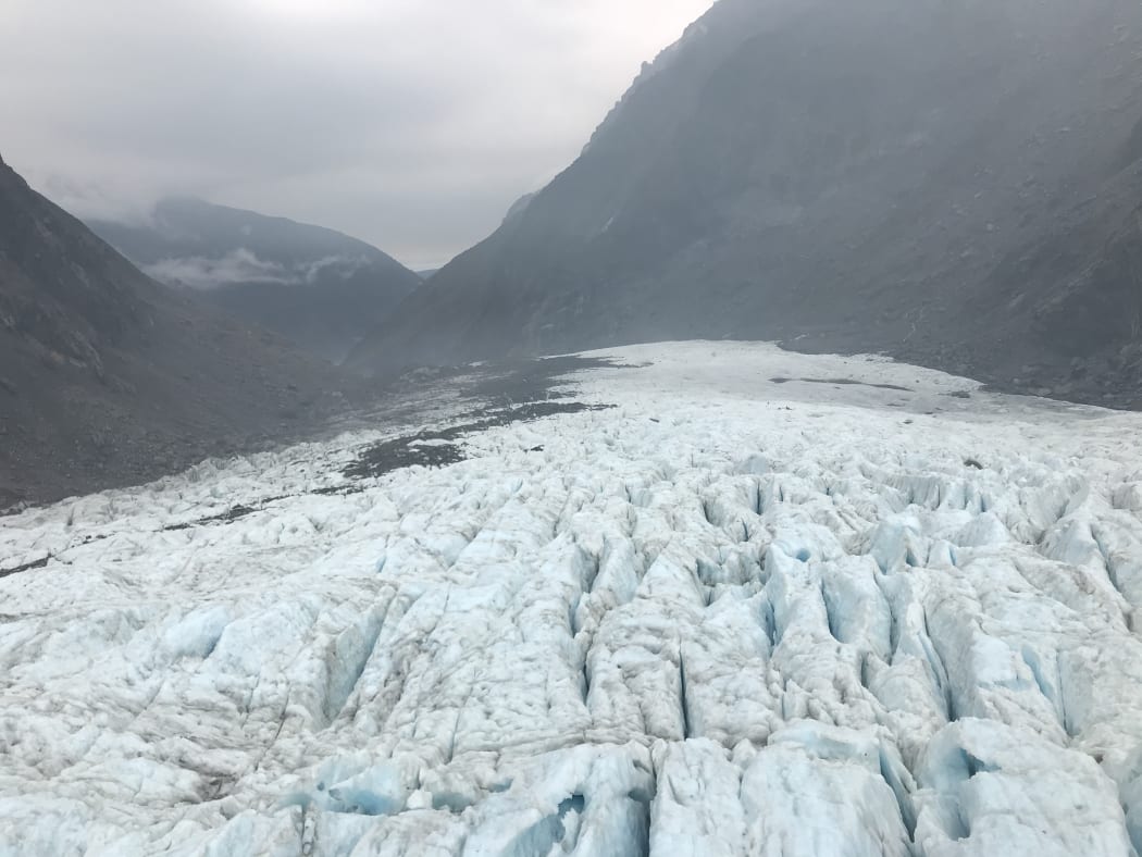 Ice at Fox Glacier seen with some yellowy ash patches on 1 January, 2020, after smoke from Australia's ongoing bushfires drifted across the Tasman.