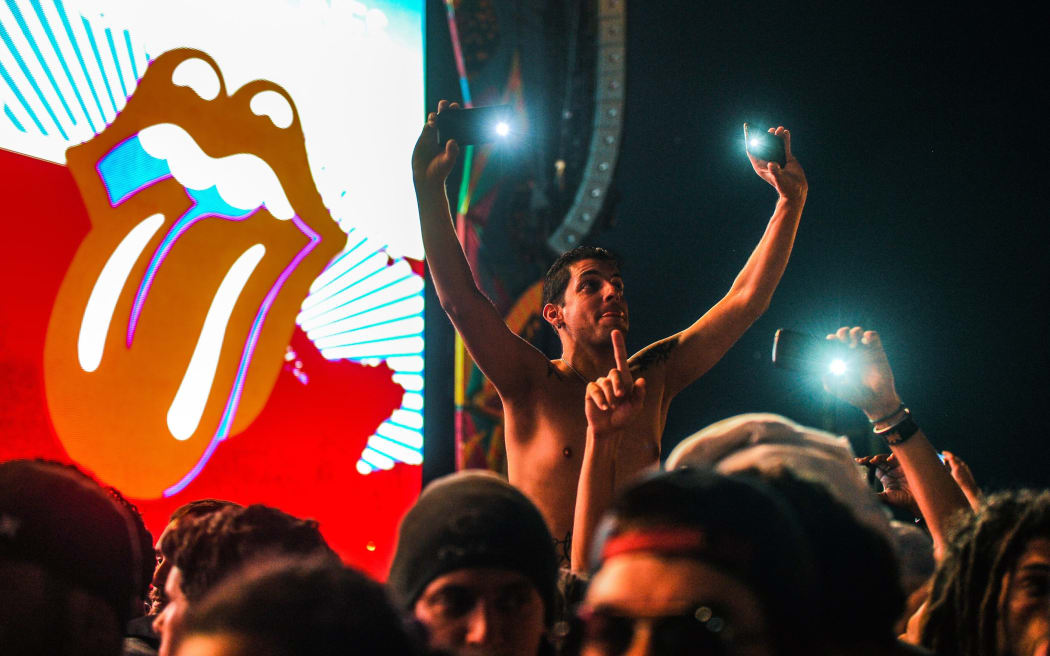Fans take pictures at the free Rolling Stones concert which was being hailed as an historic event.
