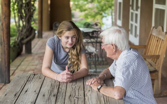 [New Mexico, United States] A teenage girl having a conversation with her grandfather (Photo by Mint Images / Mint Images / Mint Images via AFP)