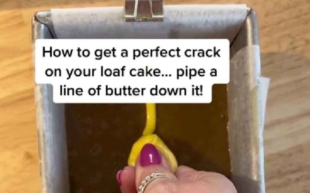 hand piping butter into a cake