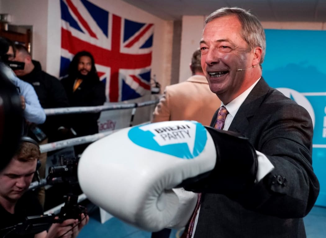 Brexit Party leader Nigel Farage poses for a photograph in boxing gloves during his visit to Gator ABC Boxing Club in Ilford, east London on November 13, 2019.