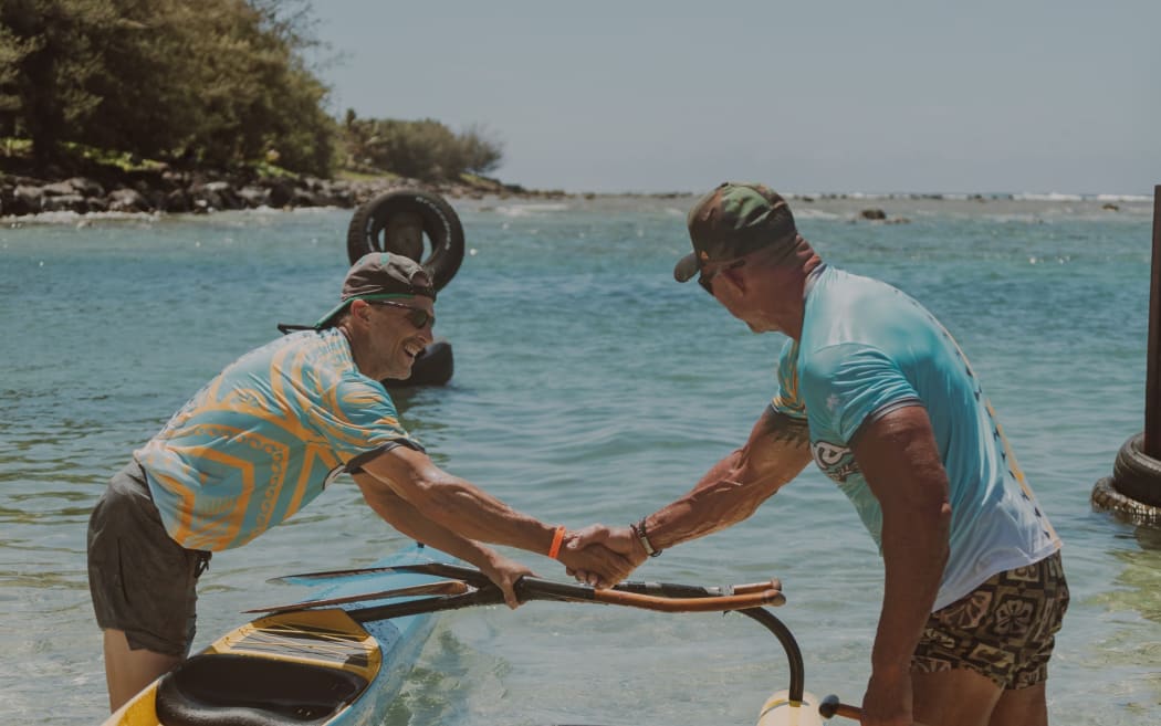Paddlers congratulate each other upon crossing the finish line.