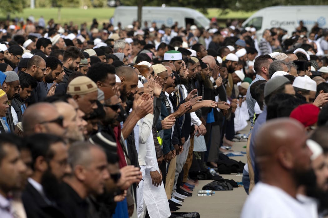 Muslims participate in Friday prayers led by Gamal Fouda, imam of Al Noor mosque, during a gathering for prayers and to observe two minutes of silence for victims of the twin mosque massacre at Hagley Park, Christchurch,March 22, 2019.(Photo by Marty MELVILLE / AFP)