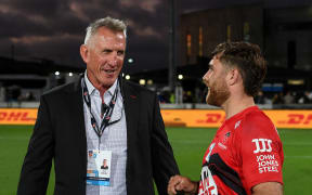 A happy Rob Penney talks with Kyle Preston.