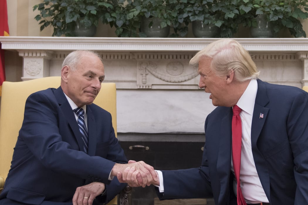 Donald Trump shakes hands with newly sworn-in White House chief of staff, retired General John Kelly.