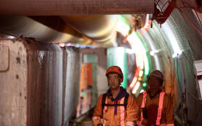 Workers prepare the tunnel boring machine to dig the tunnel for the central interceptor stormwater system under the Manukau Harbour.