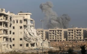 Smoke rises after Syrian opponents attacked the headquarters of Assad regime forces with bomb-laden vehicles during an operation to break the siege of the regime forces in the city center, in Aleppo, Syria