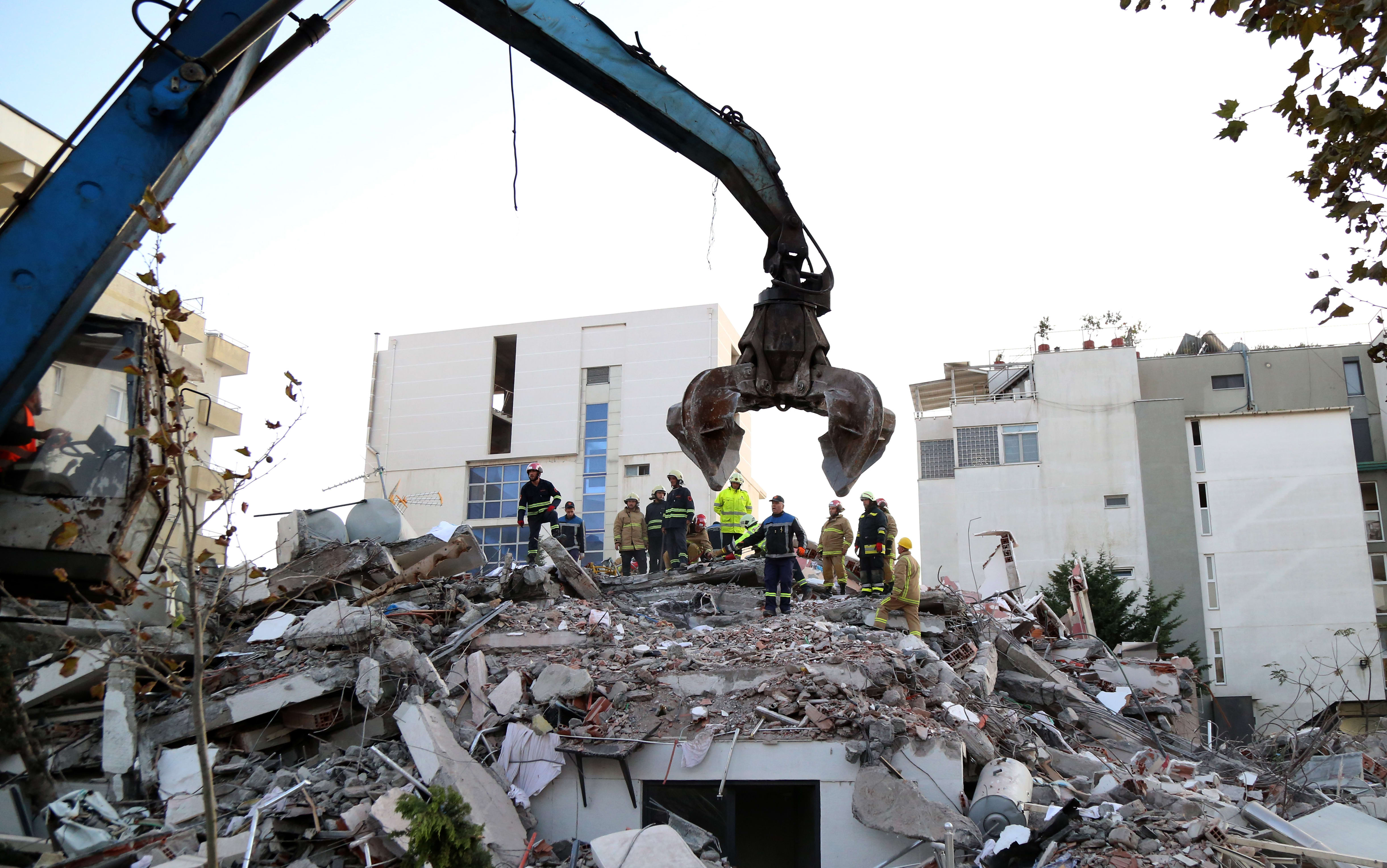 Emergency workers look for survivors trough the rubble of a damaged building in the coastal city of Durres, west of capital Tirana, after an earthquake hit Albania, on November 26, 2019.