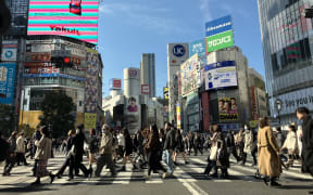 People cross Shibuya Scramble Crossing in Tokyo on Jan. 30, 2024. ( The Yomiuri Shimbun ) (Photo by Kanshiro Sonoda / Yomiuri / The Yomiuri Shimbun via AFP)