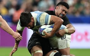 Rodrigo Bruni is tackled by Ardie Savea during the Rugby World Cup semi-final match between Argentina and New Zealand at the Stade de France in Saint-Denis.
