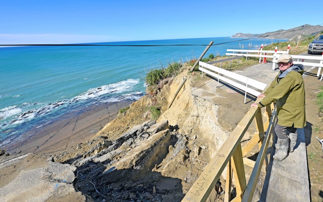 Greg Shelton standing above the slip, on a temporary footbridge built by the small coastal community.