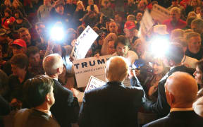Republican presidential candidate Donald Trump greets people at a campaign rally at the Sioux City Orpheum Theatre in Sioux City, Iowa on 31 January 2016.