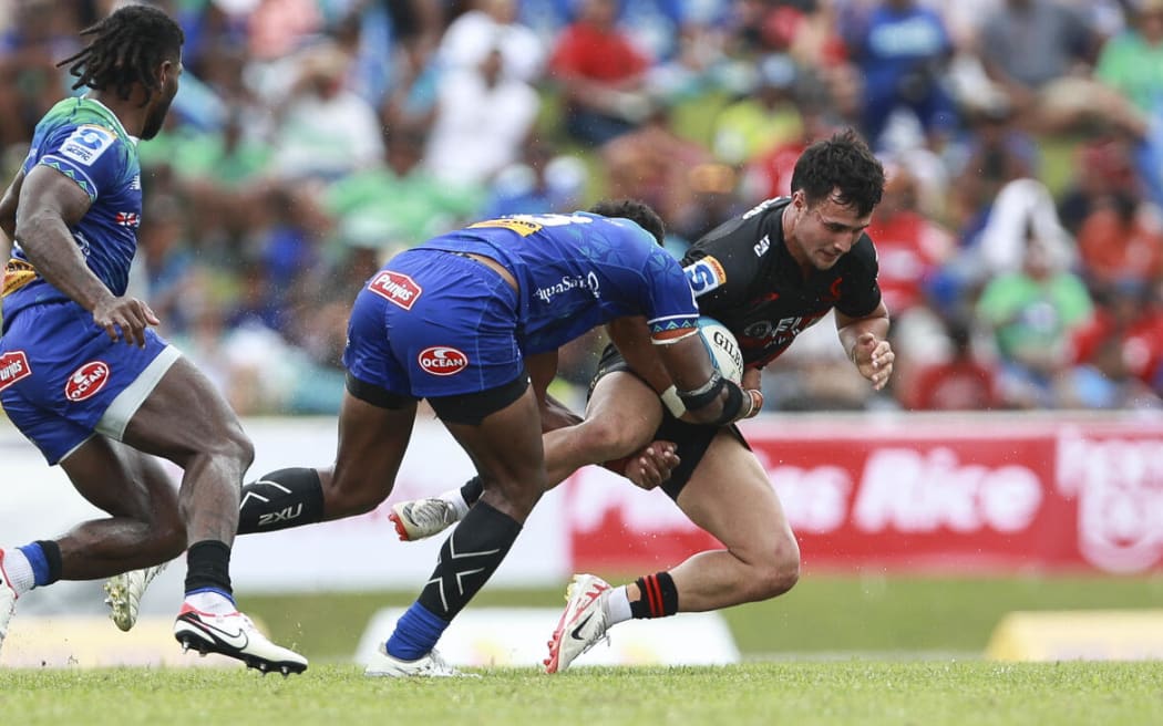 Will Jordan is tackled against the Fijian Drua.
