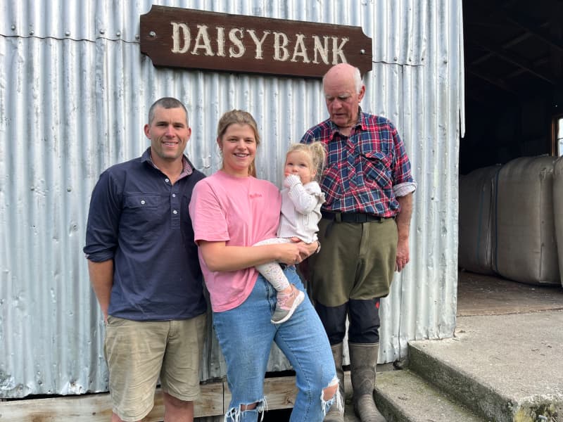 Owen and Emma Harvey, with daughter McKenzie, stand alongside John Harvey, in front of the old woolshed at Daisybank Farm.