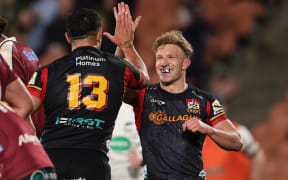 Damian McKenzie celebrates Anton Lienert-Brown’s try during the Super Rugby Pacific quarter final match between the Chiefs and Queensland Reds at FMG Stadium in Hamilton.
