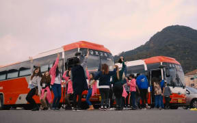 K-pop World Festival competitors practice their moves before getting on a bus