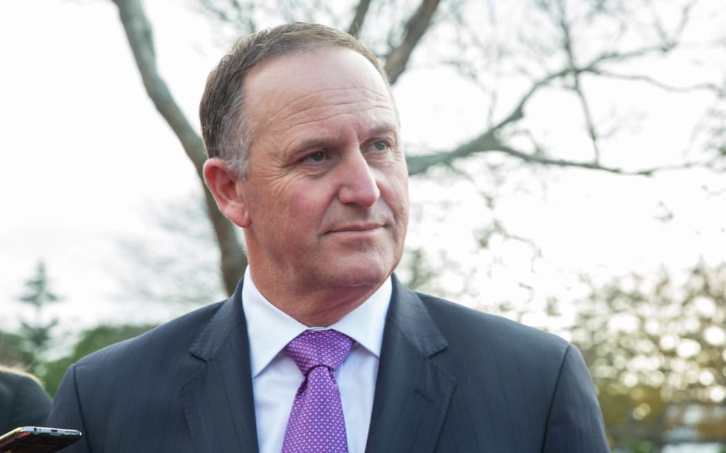 Prime Minister John Key talks to media outside of Rainbows End. 16 June 2016.