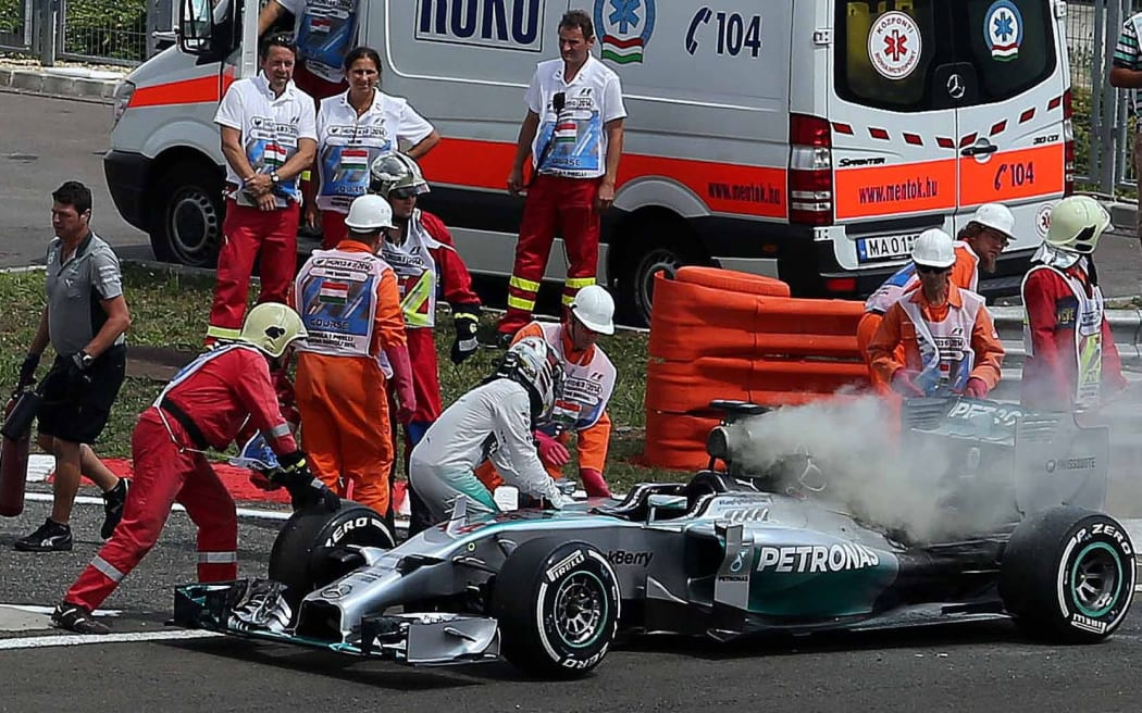 Lewis Hamilton jumps from his burning Mercedes during qualifying in Hungary, 2014.