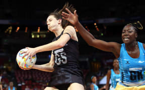 Silver Ferns shooter Bailey Mes catches the ball as Barbados goalkeeper Shonette Bruce tries for the intercept at Allphones Arena, Sydney, August 7th 2015