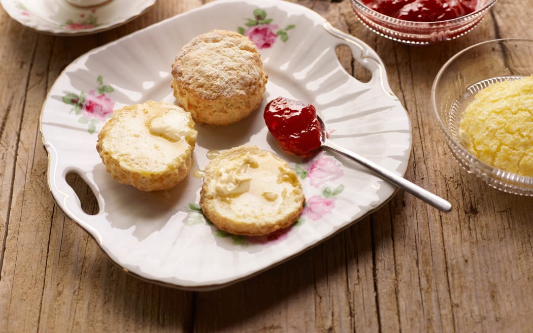 Afternoon tea of with fresh baked scones with jam and clotted cream (Photo by Tim MacPherson / Cultura Creative / Cultura Creative via AFP)