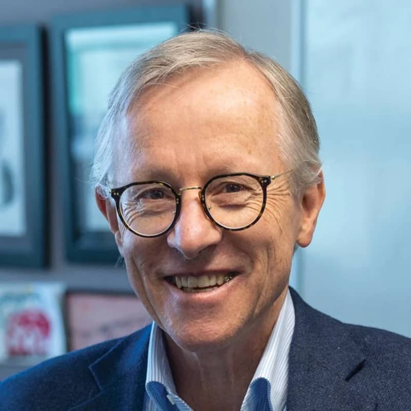 Richard Beasley is a smiling, grey-haired man in black-rimmed glasses.