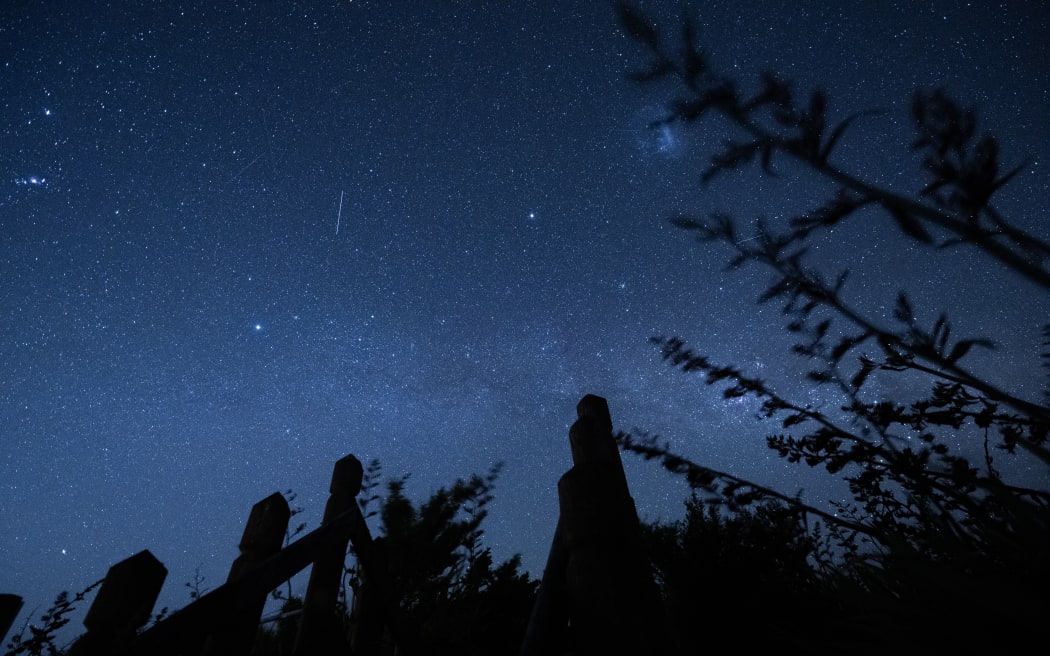 Meteors from the Phoenicids meteor shower are streaking across the sky in Lincoln, Canterbury region, New Zealand, on December 9, 2023. Meteor showers occur when multiple space rocks, known as meteorites, enter our atmosphere simultaneously at high speed and burn up, creating the appearance of shooting stars or fireballs. Scientists are saying that New Zealand is the best place in the world to witness this rare meteor shower on December 12th. (Photo by Sanka Vidanagama/NurPhoto) (Photo by SANKA VIDANAGAMA / NurPhoto via AFP)