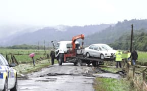 Flood victim's car being towed away.