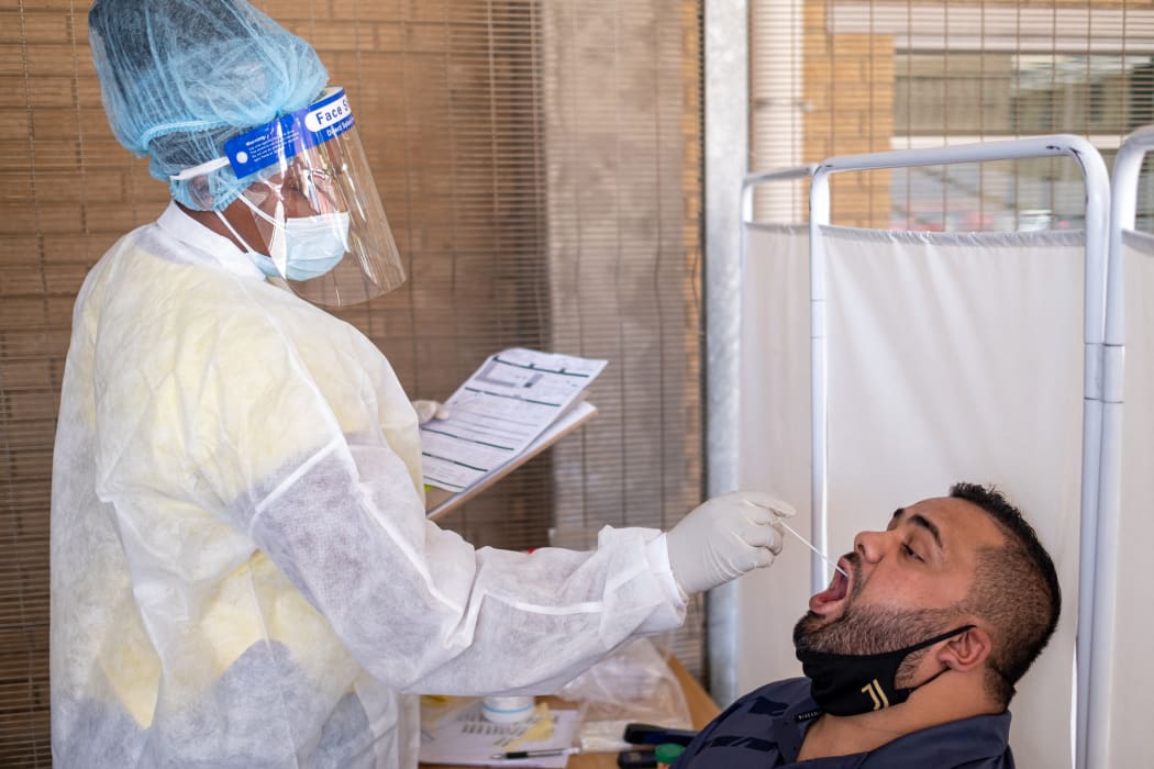 A healthcare worker conducts a PCR Covid-19 test at the Lancet laboratory in Johannesburg on November 30, 2021 as a new, heavily mutated Covid-19 variant, dubbed omicron, spread across the globe.