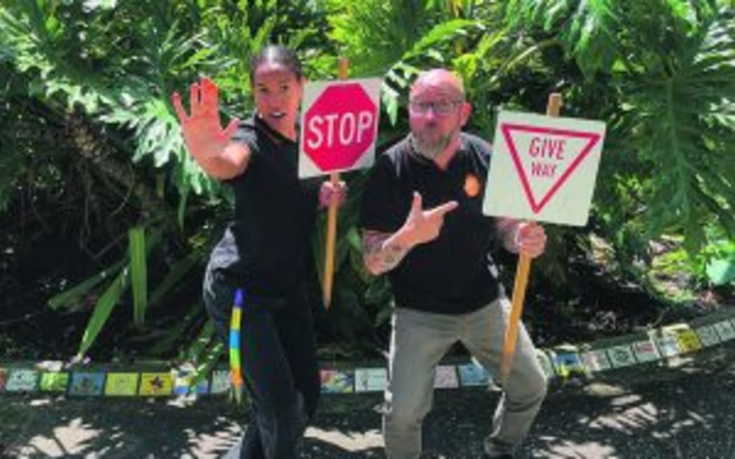 Whakatāne District Council community safety advisor Richard Hamer and intern Annelle Prince pose with Give Way and Stop road signs.