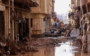 Overturned cars lie among other debris caused by flash floods in Derna, eastern Libya, on September 11, 2023.
