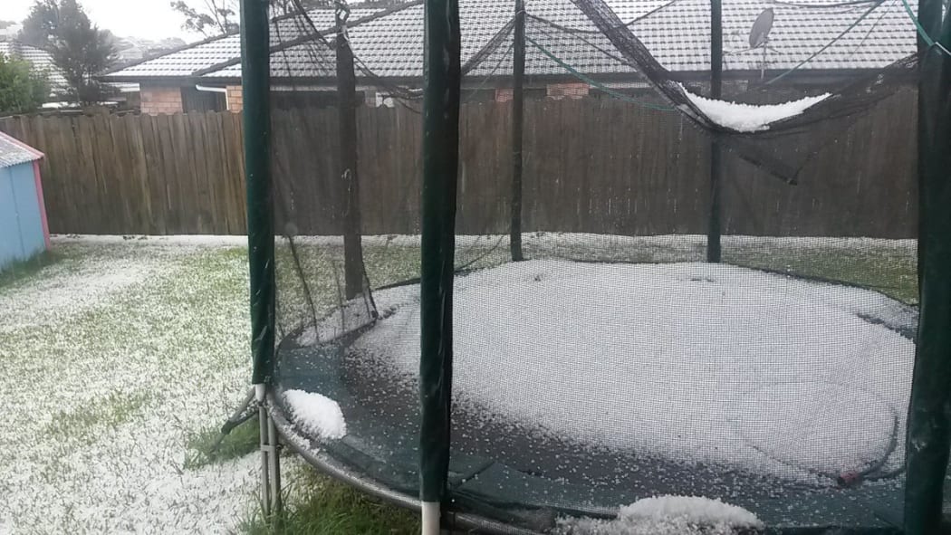 Hail fills a trampoline in a west Auckland backyard.