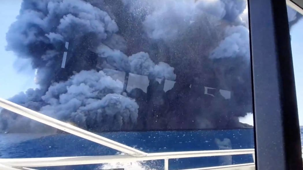 The eruption seen from the tourists' boat after they had left the island.