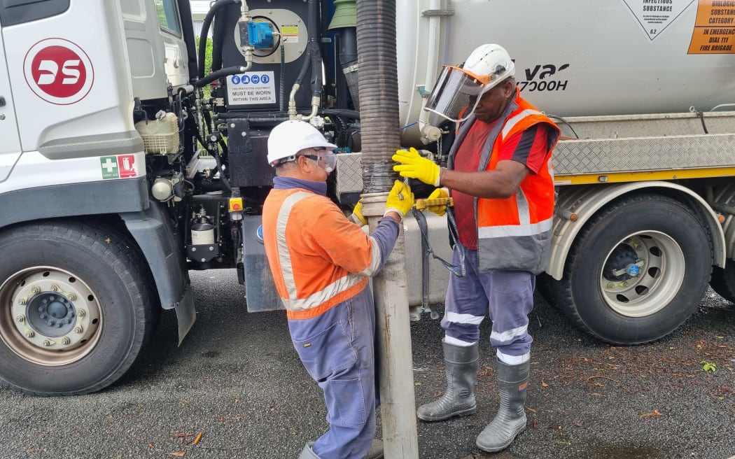 Contractors clearing drains on London Street, Ponsonby, on Monday. 30 January, 2023