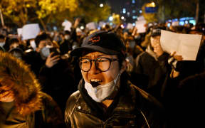 Protesters during a rally for the victims of a deadly fire as well as a protest against China's harsh Covid-19 restrictions in Beijing on 28 November, 2022.