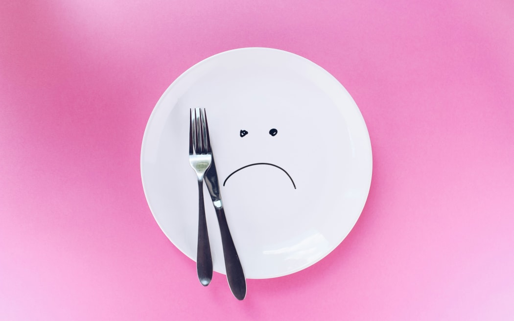A plate with a grumpy face drawn on it