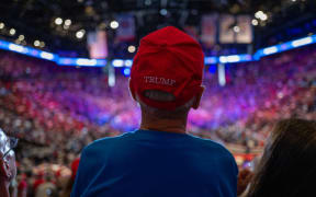 UNIONDALE, NEW YORK - SEPTEMBER 18: Supporters watch and cheer as former President Donald Trump speaks at an evening rally in Uniondale on Long Island on September 18, 2024 in Uniondale, New York. Security at the event is tight following the arrest of an individual over the weekend hiding with a gun at Trump’s Florida golf course.   Spencer Platt/Getty Images/AFP (Photo by SPENCER PLATT / GETTY IMAGES NORTH AMERICA / Getty Images via AFP)